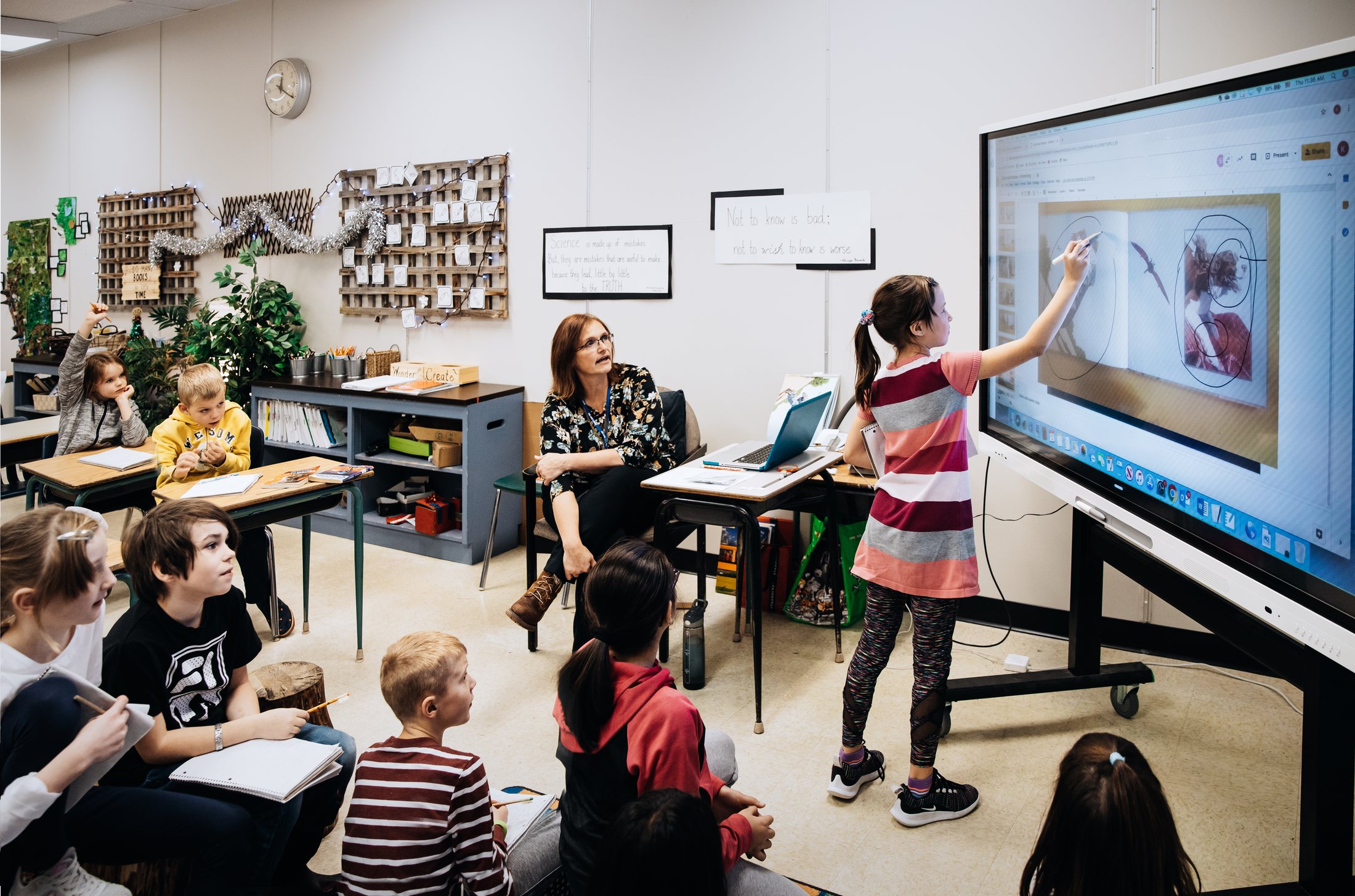 Students at a Technetix SMART interactive display in a modern classroom
