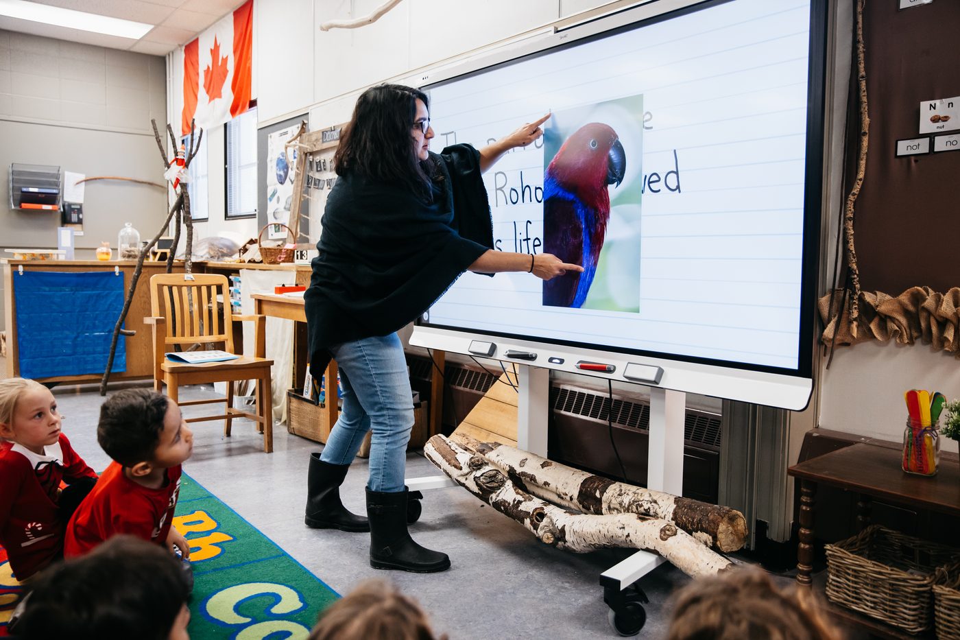 Teacher and students at an interactive display